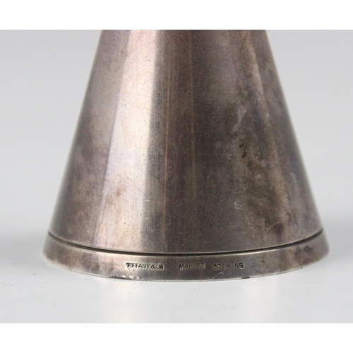 101 - A Tiffany and Co white metal double spirit measure, of plain polished conical form with grooved bord... 