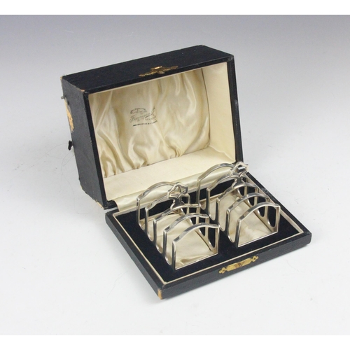 104 - A near pair of cased George V silver toast racks, Adie Brothers Ltd, Birmingham 1930/31, retailed by... 