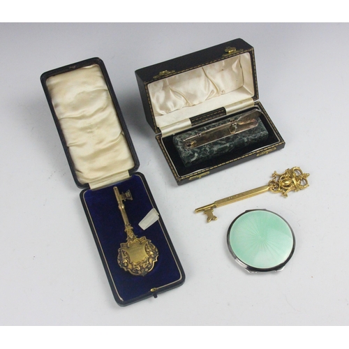 106 - A selection of silver and gold coloured items, including a George VI silver and enamel compact, the ... 