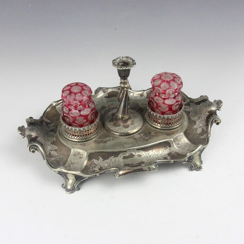 125 - A 19th century silver plated desk tidy, the scroll handle above florally engraved detail and crest t... 