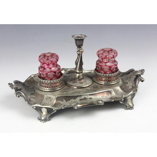 125 - A 19th century silver plated desk tidy, the scroll handle above florally engraved detail and crest t... 