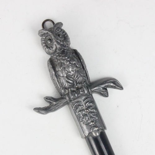 126 - A novelty hanging thermometer, designed as a sword with owl shaped hilt and oak leaf detailed termin... 