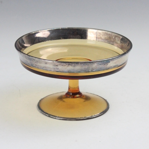 127 - A 20th century silver coloured metal mounted centre piece, the circular amber coloured glass place w... 