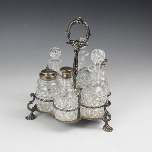 132 - A Victorian silver plated cruet stand, the scroll handle supporting six cut glass condiments (two si... 