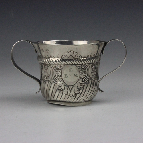 16 - A George II silver porringer, possibly John Bayley, London 1750, the twin grooved strap handles abov... 