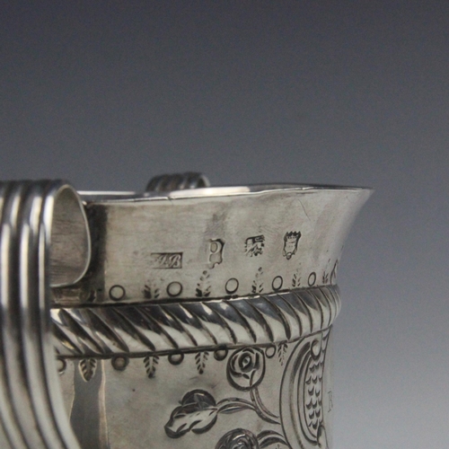 16 - A George II silver porringer, possibly John Bayley, London 1750, the twin grooved strap handles abov... 