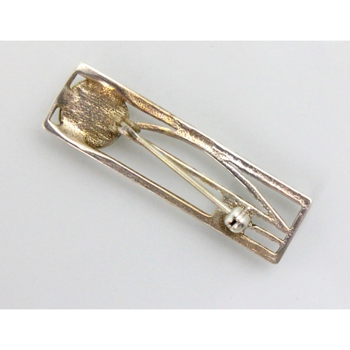 182 - A late 20th century Rennie Macintosh style silver brooch, the openwork stylised flower head design w... 