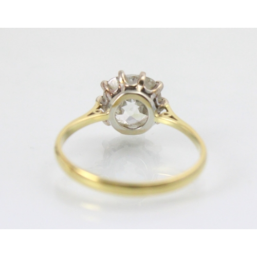 284 - A 20th century diamond solitaire ring, the old cut diamond with white metal claws leading to plain p... 