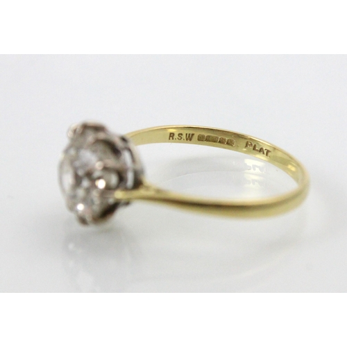 284 - A 20th century diamond solitaire ring, the old cut diamond with white metal claws leading to plain p... 