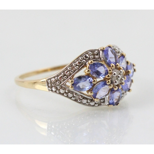 199 - An untested tanzanite and diamond ring, the four round cut diamonds in cluster design within surroun... 