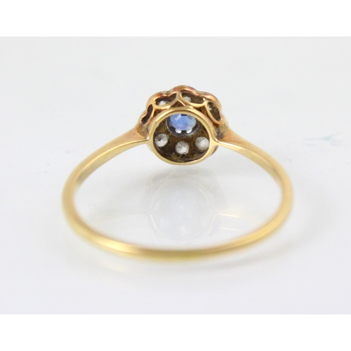 201 - An early 20th century untested sapphire and diamond cluster ring, the round cut blue stone within su... 