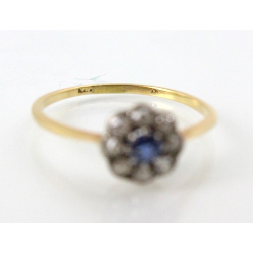 201 - An early 20th century untested sapphire and diamond cluster ring, the round cut blue stone within su... 