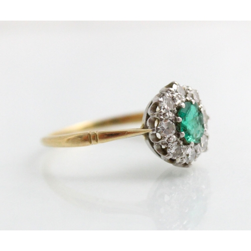 203 - An Edwardian style untested emerald and diamond cluster, the emerald cut green stone within surround... 