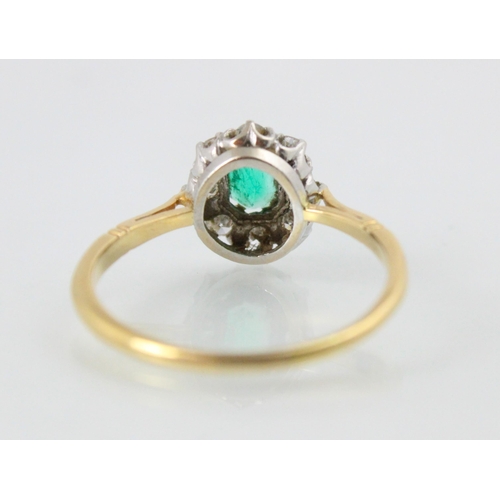 203 - An Edwardian style untested emerald and diamond cluster, the emerald cut green stone within surround... 