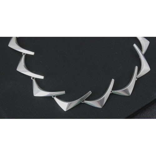 219 - An Anton Michelsen silver 'boomerang' necklace, designed by Eigil Jensen, the plain polished stylise... 