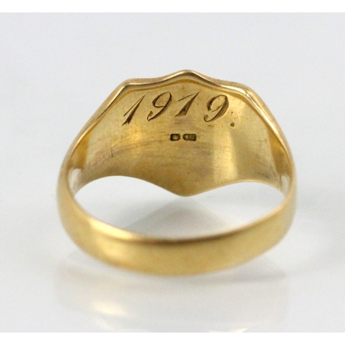 231 - An early 20th century 18ct yellow gold signet ring, the shield shaped head with engraved monogram, l... 