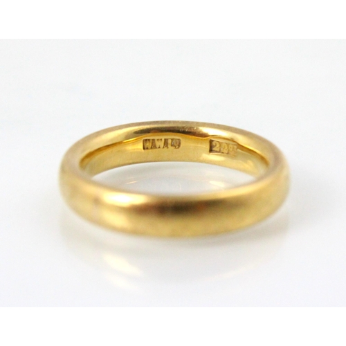 232 - A yellow metal wedding band, stamped ‘22ct’ ‘WWLd’ ring size J ½, 7gms