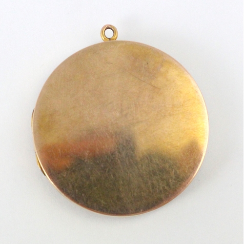 233 - An early 20th century 9ct yellow gold pendant/locket, the plain polished circular locket opening to ... 