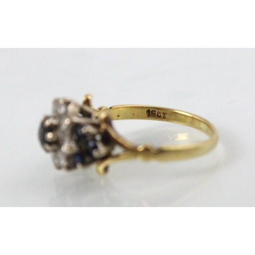 237 - A yellow metal untested sapphire and diamond cluster ring, the central round cut untested sapphire w... 