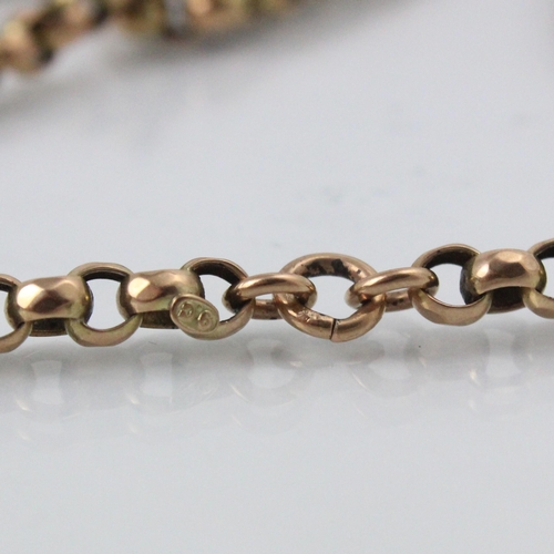 244 - An early 20th century yellow metal long guard chain, the lightly faceted spherical links with applie... 