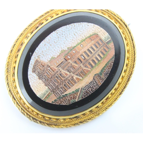 271 - A 19th century Italian micro mosaic brooch, the oval brooch depicting The Colosseum, Rome, encompass... 