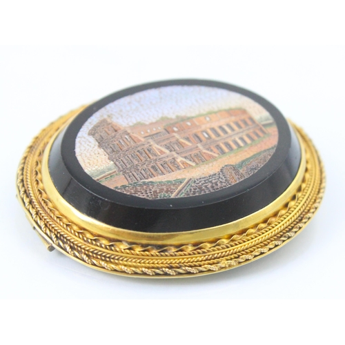 271 - A 19th century Italian micro mosaic brooch, the oval brooch depicting The Colosseum, Rome, encompass... 