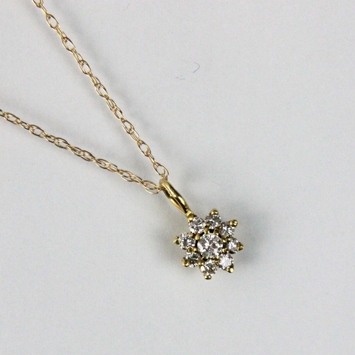 282 - An 18ct yellow gold diamond pendant, the central raised round cut diamond within surround of eight s... 