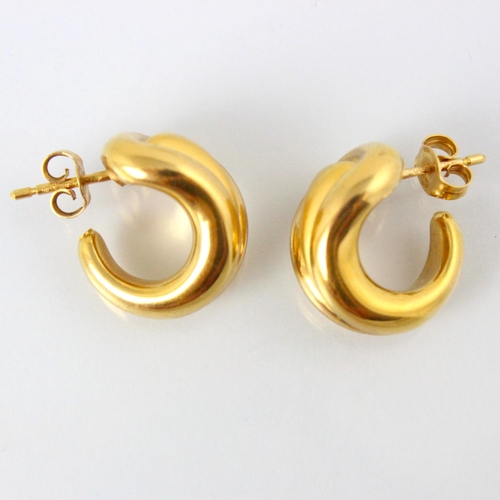 296 - A pair of yellow metal hoop earrings, the stylised hoops with matte detail to the centre with plain ... 