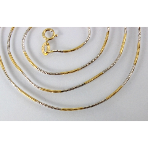 297 - A yellow metal two tone chain, the snake link chain with yellow metal detail in-between engraved whi... 