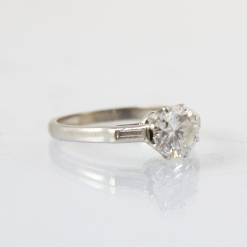 324 - A mid 20th century diamond solitaire ring, the round cut diamond within white metal eight claw setti... 