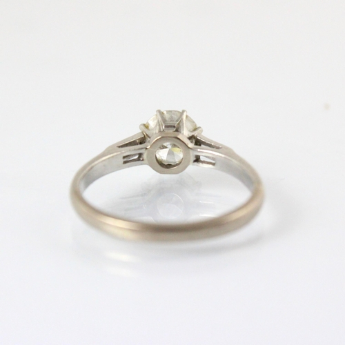 324 - A mid 20th century diamond solitaire ring, the round cut diamond within white metal eight claw setti... 