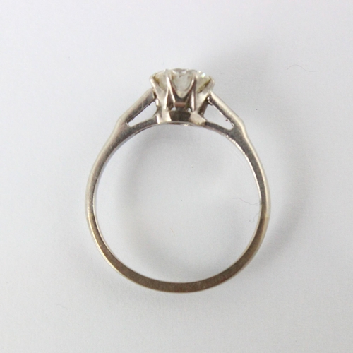 324 - A mid 20th century diamond solitaire ring, the round cut diamond within white metal eight claw setti... 