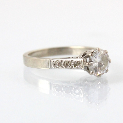 326 - A 20th century diamond solitaire ring, the round cut diamond within white metal eight claw setting e... 