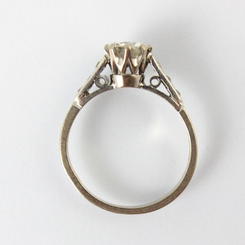 326 - A 20th century diamond solitaire ring, the round cut diamond within white metal eight claw setting e... 