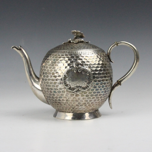 89 - A 20th century continental white metal teapot, Julius Lemor, the cast floral finial above planished ... 