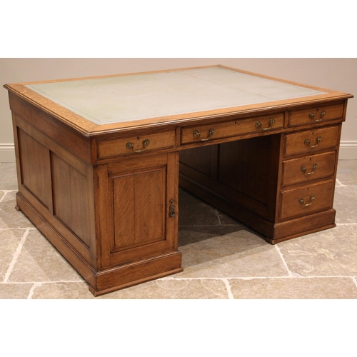 1001 - A Victorian golden oak partners desk, the rectangular moulded top inset with a green gilt tooled ski... 