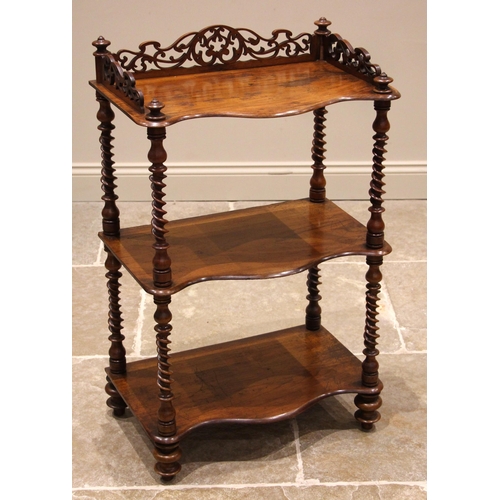 1002 - A Victorian walnut three tier what-not, of serpentine form, the upper tier with a fret work three qu... 