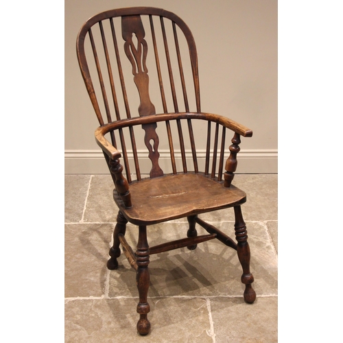 1012 - A 19th century ash and elm Windsor elbow chair, the hoop back with a central pierced splat over a sh... 