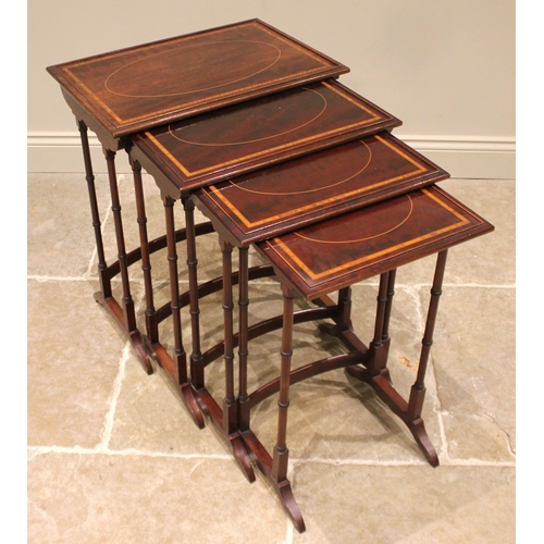 1028 - An Edwardian quartetto nest of mahogany tea tables, each table with a beaded gallery and satinwood c... 