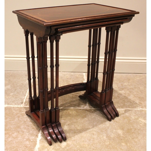 1028 - An Edwardian quartetto nest of mahogany tea tables, each table with a beaded gallery and satinwood c... 