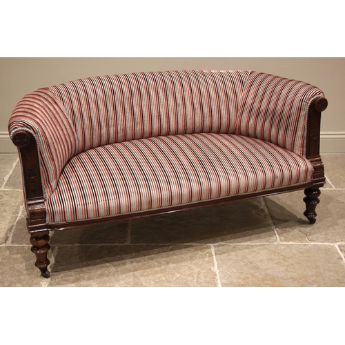 1031 - An Edwardian walnut two seater sofa, of curved bow form, later re-upholstered in multi coloured stri... 