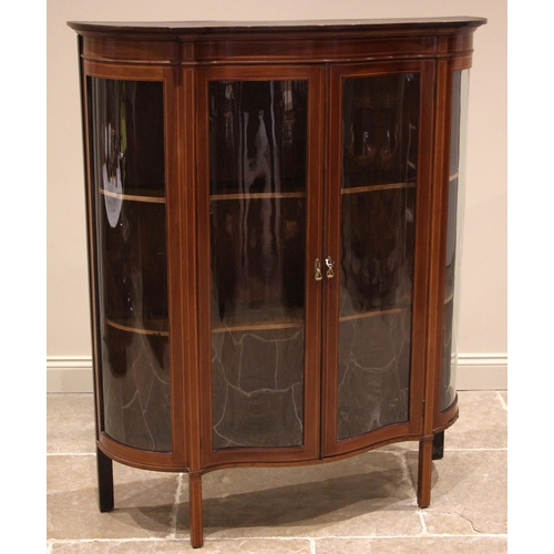 1032 - An Edwardian mahogany display cabinet, of serpentine form, outlined with boxwood stringing the pair ... 