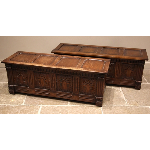 1035 - A pair of 17th century style oak coffers, 20th century, each with a four panel hinged cover over a n... 