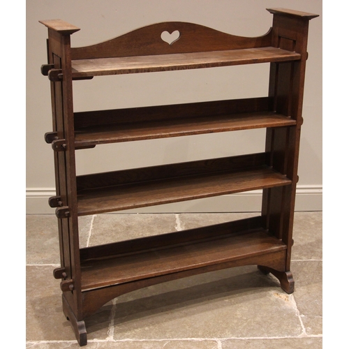 1038 - An Arts & Crafts oak open bookcase, the arched gallery to the upper shelf pierced with a heart shape... 