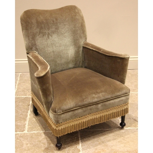 1041 - An Edwardian green velour upholstered tub chair, the serpentine shaped back rest extending to out sw... 