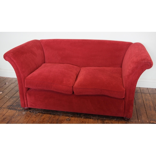 1049 - A contemporary two seater Heals type sofa, in red velour fabric, the out swept arms enclosing a pair... 