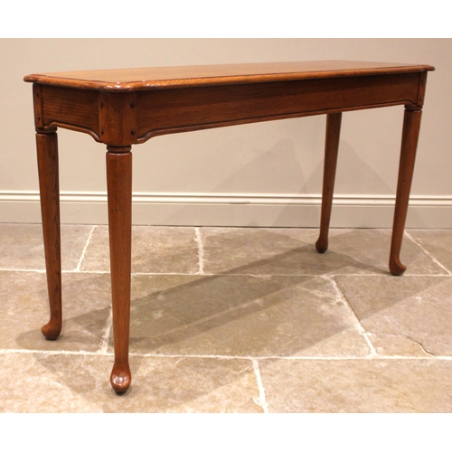 1053 - A Georgian style golden oak side table, late 20th century, the shaped and moulded top over a frieze ... 