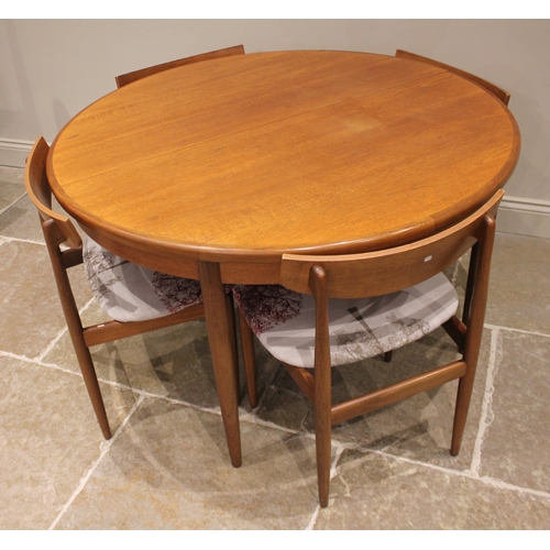 1056 - A G-Plan Fresco teak dining table, mid 20th century, the circular top with an integral folding leaf,... 