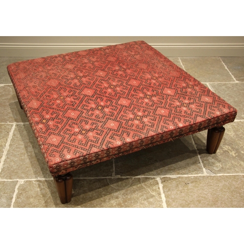 1057 - A kilim foot stool, of country house proportions, the square top covered in red and black geometric ... 