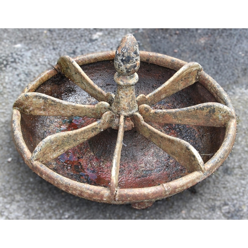 1092 - A 19th century circular cast iron feed trough, the acorn shaped finial over eight divisions 60cm D